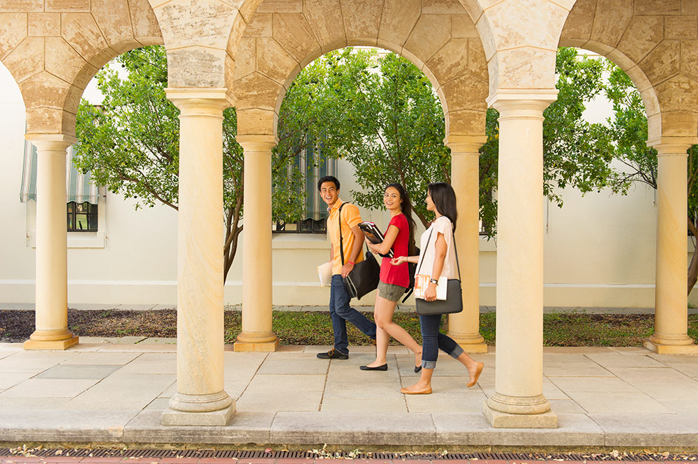 Three students walking on campus