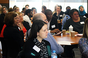 People seated listening to a speaker