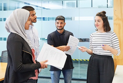 A group of people talking in an office