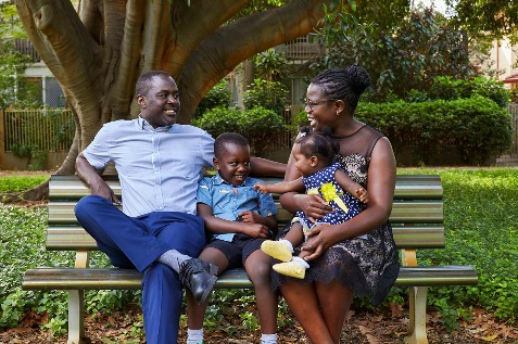 Family sitting on a park bench