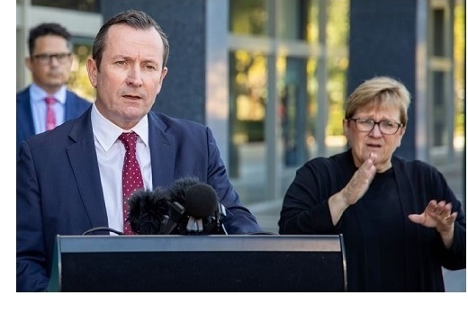 The Premier speaking with an Auslan interpreter at a press briefing