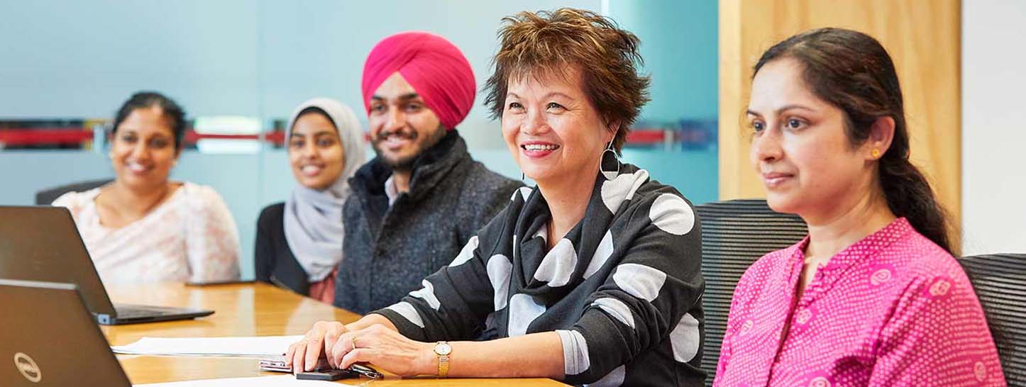 A group of people in a meeting room