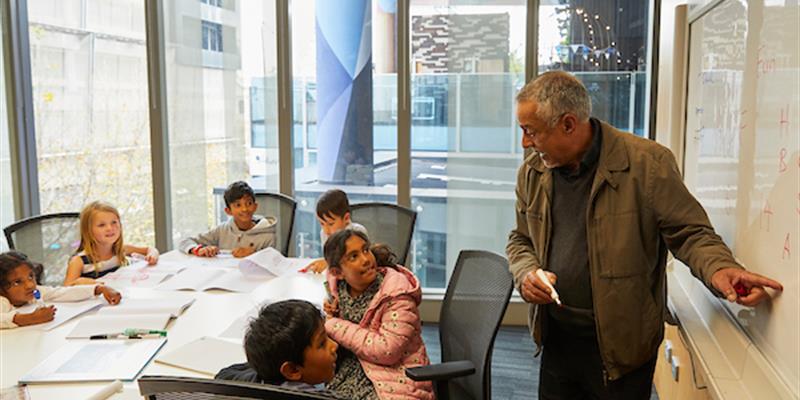 A man teaching a group of students